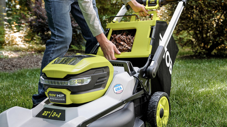 Man emptying leaves Ryobi lawn mower