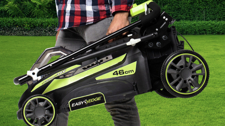 Man carrying Ryobi lawn mower