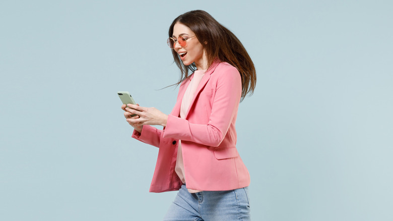 Woman running holding smartphone