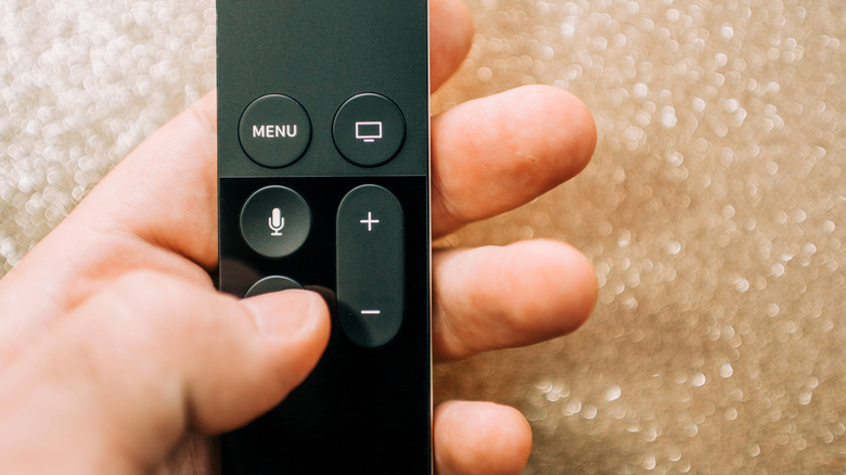 hand holding Apple TV remote control