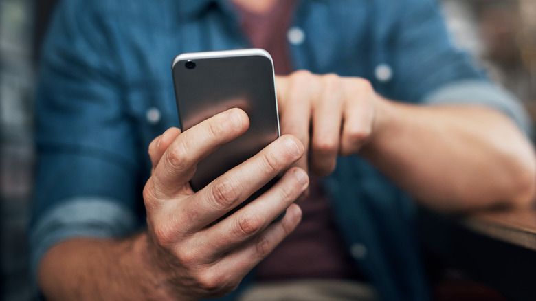 A person holding an iPhone