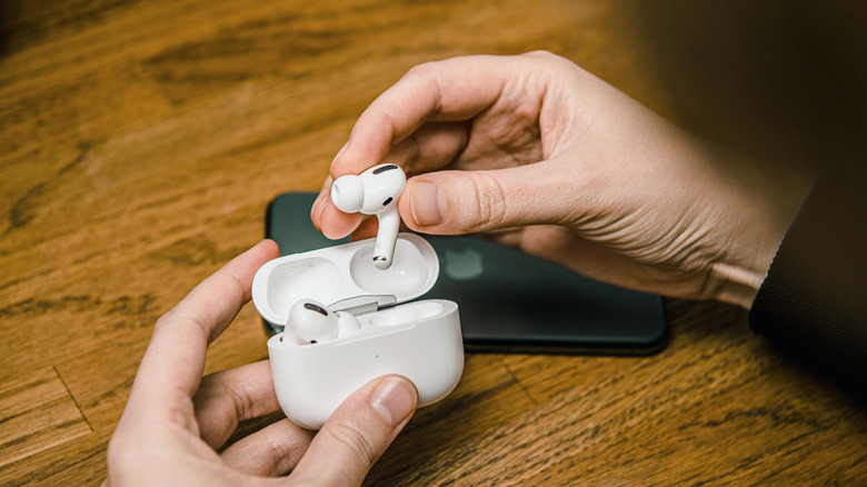 AirPods with white light inside the case