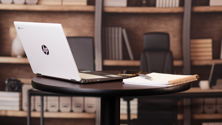 HP Chromebook with phone on table