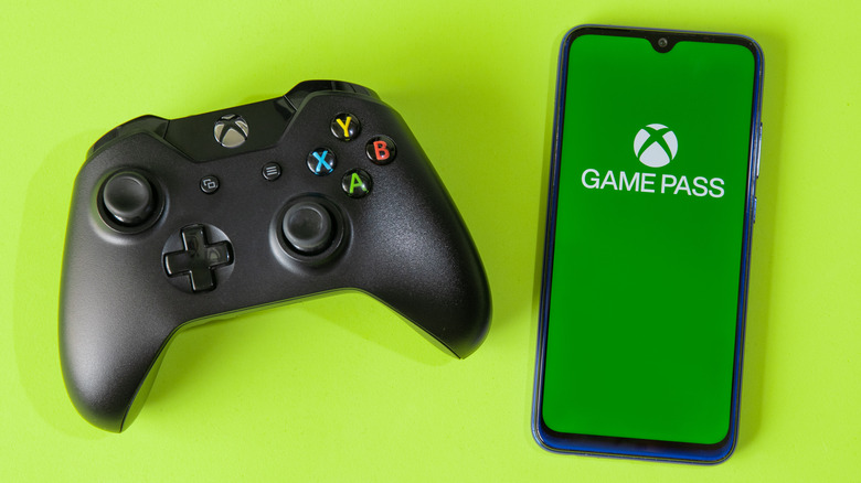 black Xbox controller and Android phone with Game Pass app