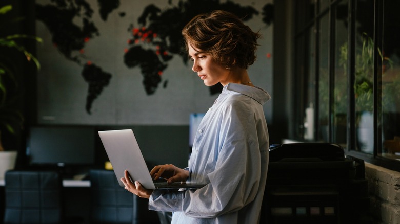 Woman with short brown hair on laptop