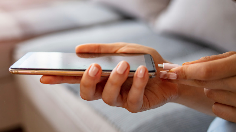 Plugging cable into smartphone