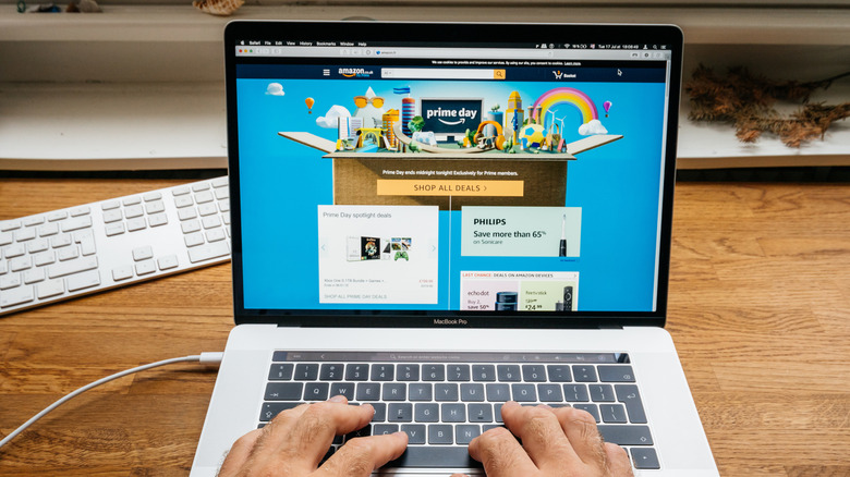 Amazon site open on a Macbook on wooden desk