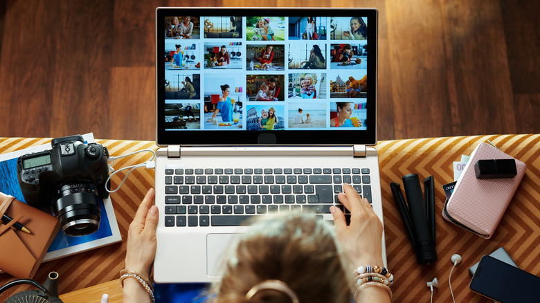 woman viewing photos on laptop