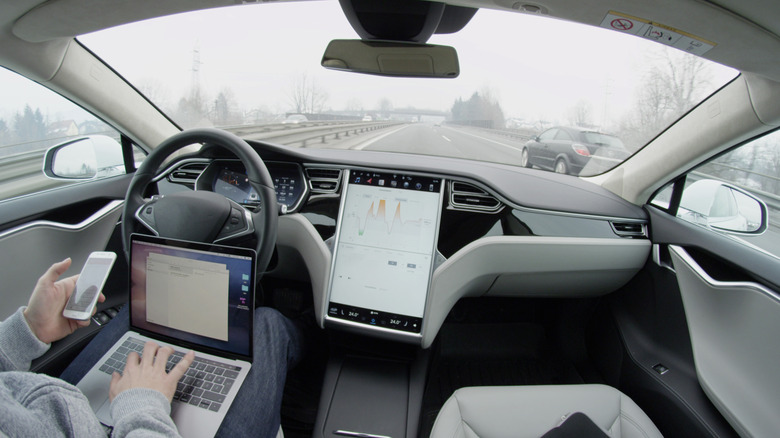 tesla owner using autopilot