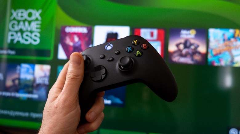 A controller on a backdrop of the Xbox user interface