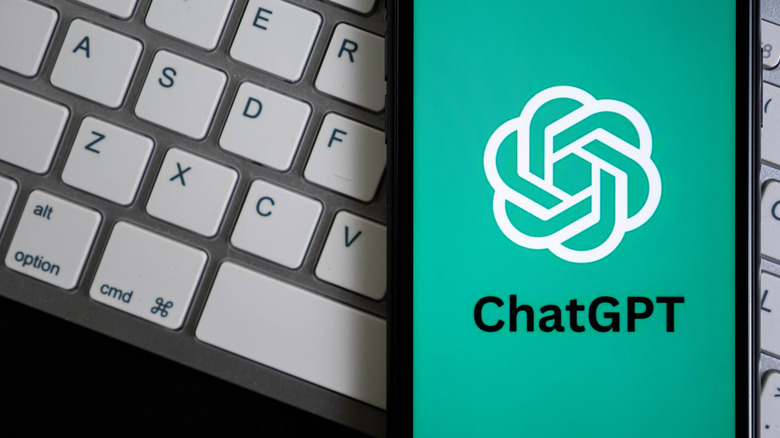 ChatGPT logo on phone over keyboard