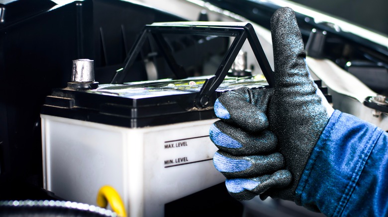 Mechanic Giving A Thumbs Up Next To A Good Battery