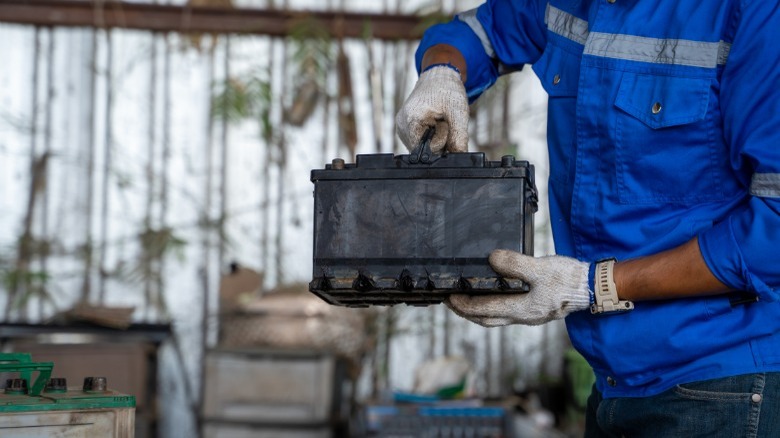 person with 12-volt car battery