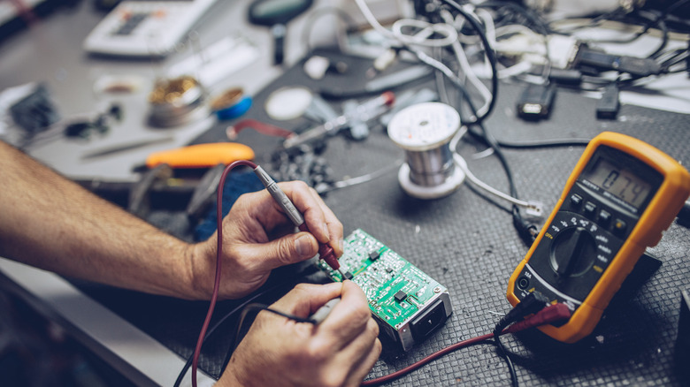 person repairing an electronic device