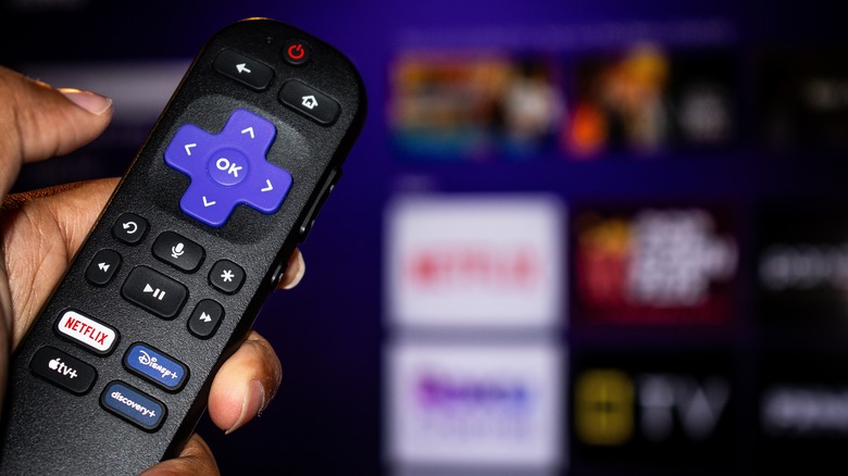 Person holding Roku remote