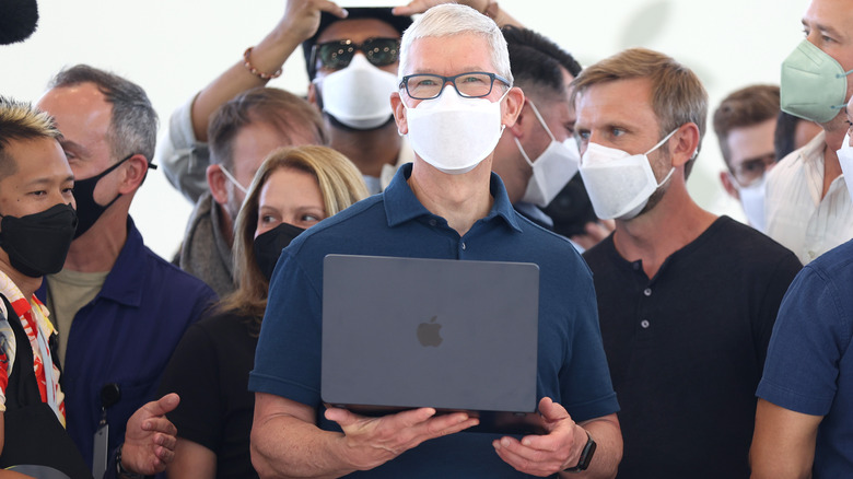 Apple CEO holding MacBook Air