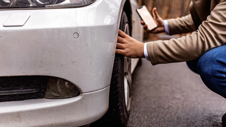 Man checking car wheels