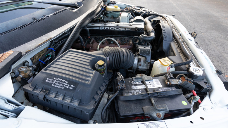 White Dodge Ram 3500 with hood open revealing Cummins engine