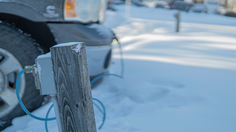 Vehicle Block Heater plugged into power pole in the snow