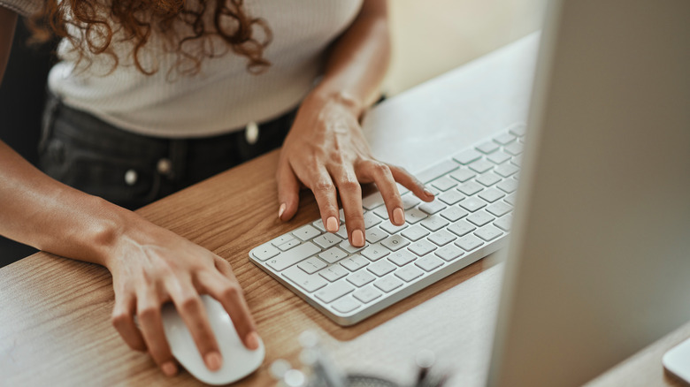 Woman using a mouse and a keyboard