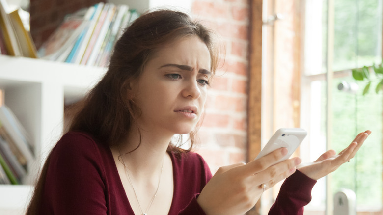 person frustrated with smartphone