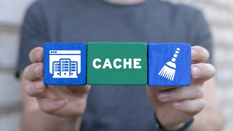 Person holding three block Cache written on one