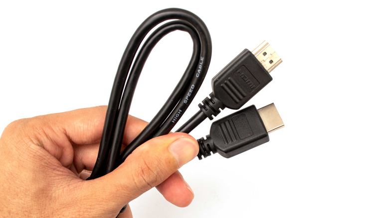 Hand holding an hdmi cable