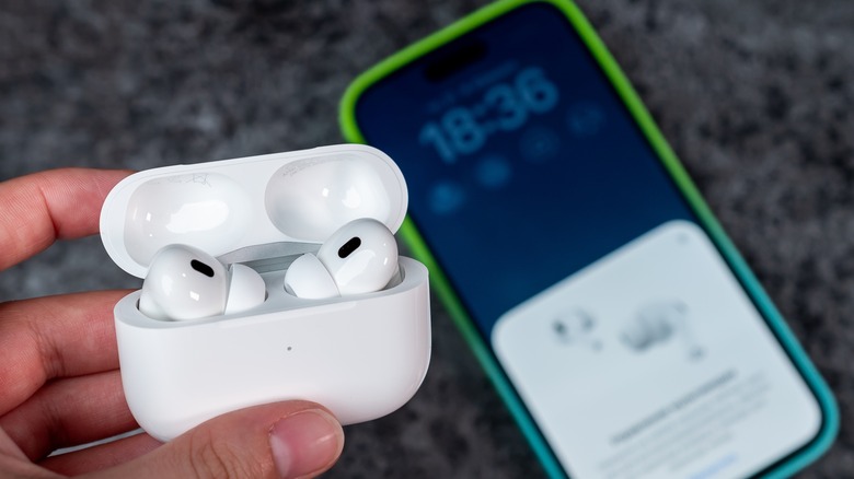 AirPods inside case next to an iPhone