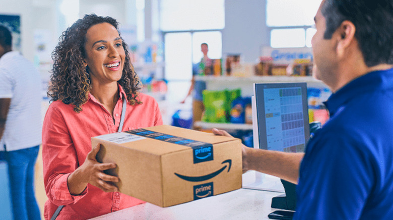 Woman picking up Amazon package from business