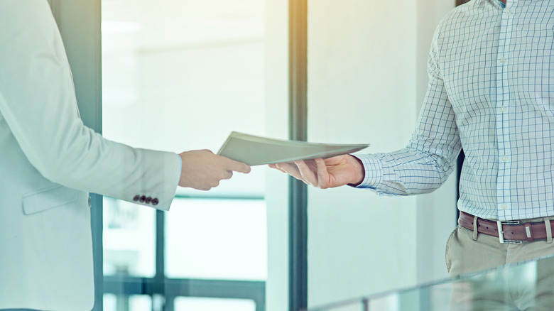 People exchanging paperwork