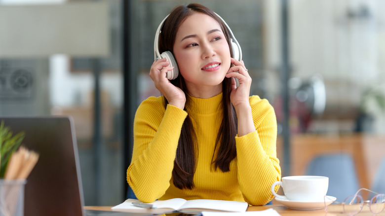 female student listening headphones