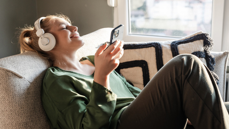 woman happily listening headphones