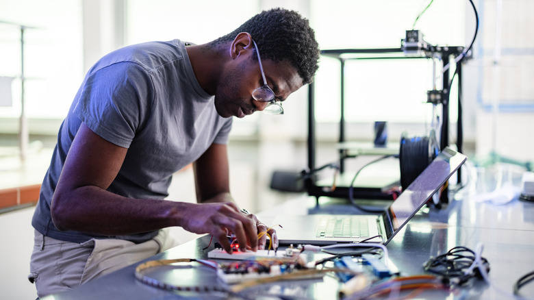 man working with computer parts