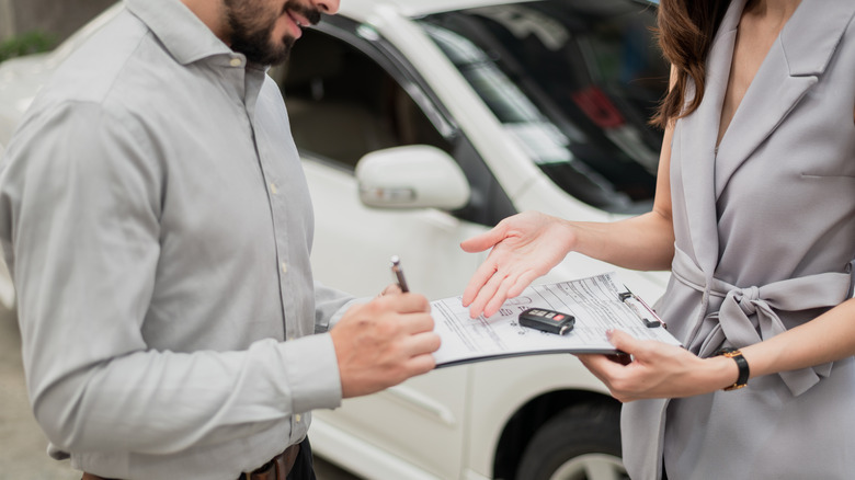 Dealership staff talks to customer