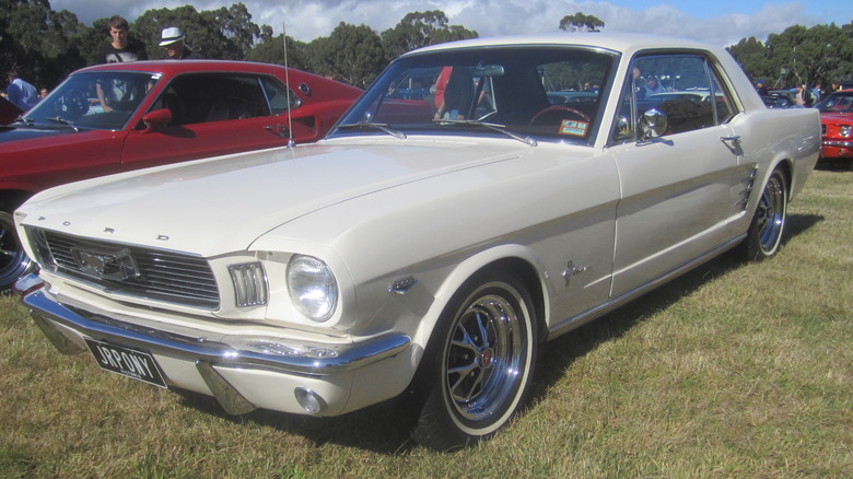 A Wimbledon White 1966 Ford Mustang K-Code Hardtop parked on grass.