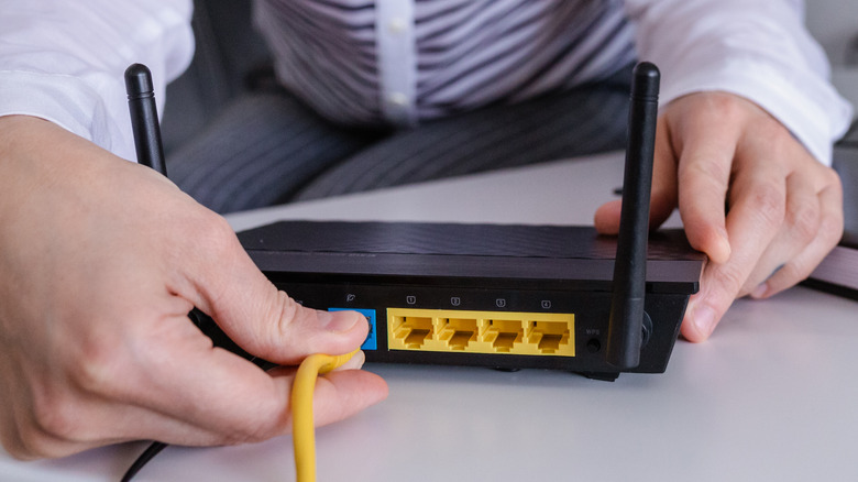 Woman connecting Ethernet cable