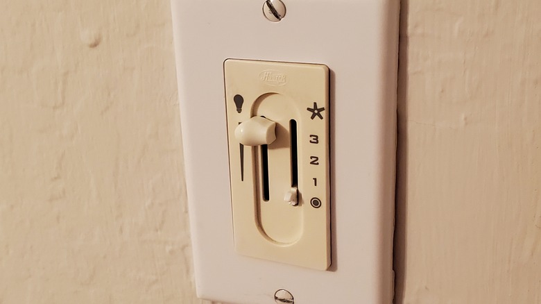 old light dimmer on wall