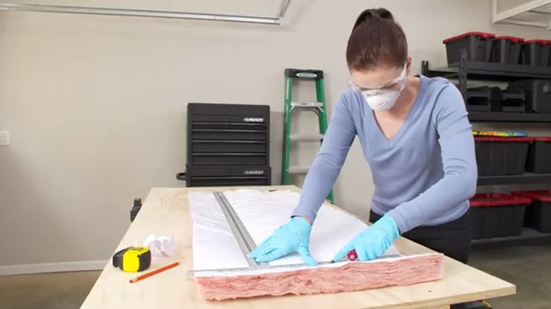 Woman cutting insulation