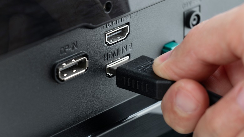 HDMI cable being plugged into TV