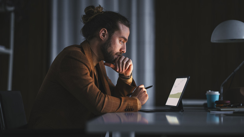 man working at night tablet