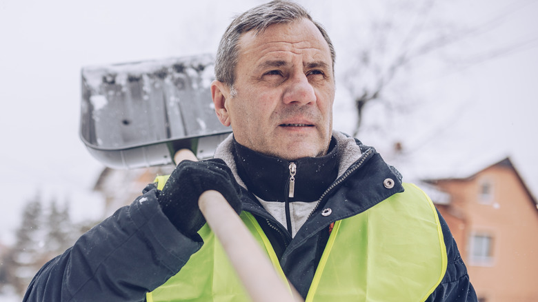 Man holding snow shovel