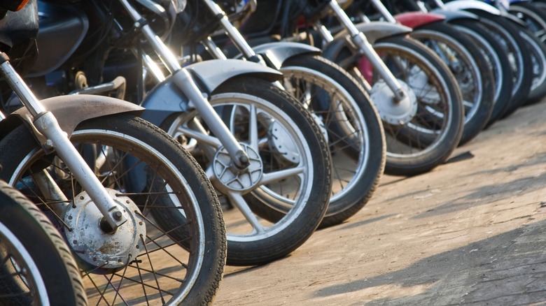 The front tires in a row of motorcycles