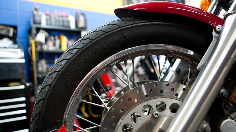 Close-up of motorcycle tire on a bike in shop