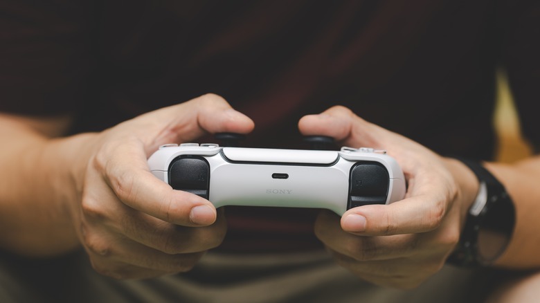 Gamer holding DualSense controller