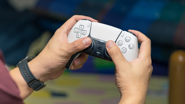 Gamer holding Sony DualSense controller