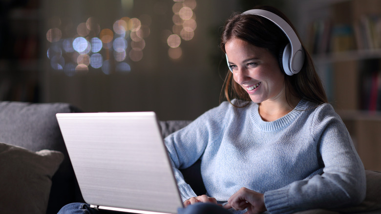 Woman playing on laptop