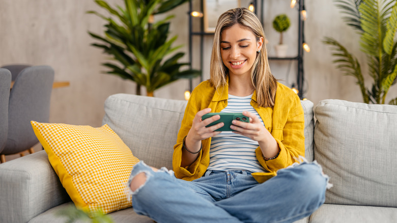 sitting on couch with smartphone