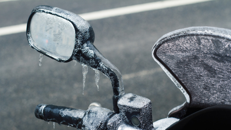 Motorcycle windshield and mirror covered in ice