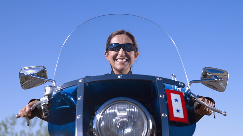 Woman behind motorcycle windshield