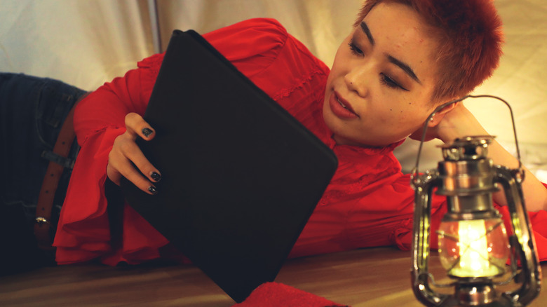 Woman using tablet in tent